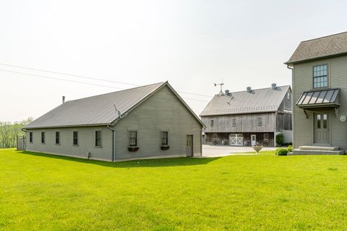 Long low outbuilding standing beside the barn and farmhouse