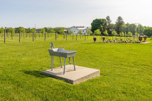 Outdoor wash basin fixture on a concrete pad in the open lawn