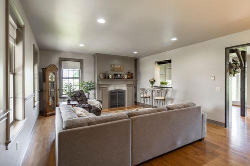 Living room with a stone fireplace, leather recliner and grandfather clock