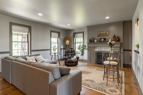Living room with a gray sectional sofa, fireplace and framed wall art