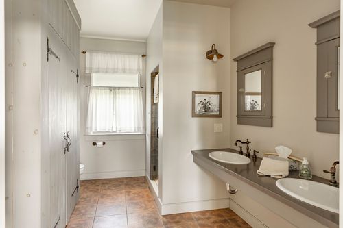 Bathroom with a walk-in closet, glass shower and double vanity