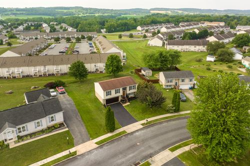 Aerial view of a two-story home with an attached garage in a suburban neighborhood