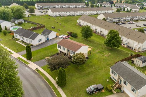 Aerial view of a home with a newly built rear deck under construction