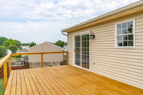 Wood deck with a sliding glass door leading into the home