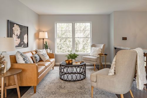 Living room with a leather sofa, coffee table and framed artwork