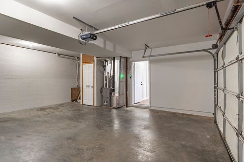 Garage interior with a utility closet and concrete flooring