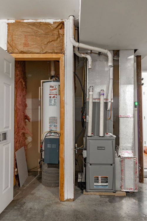 Utility closet with a water heater and furnace