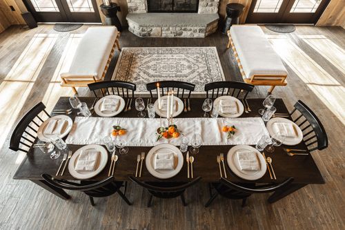 Close-up place setting with a folded linen napkin, gold flatware and a crystal wine glass