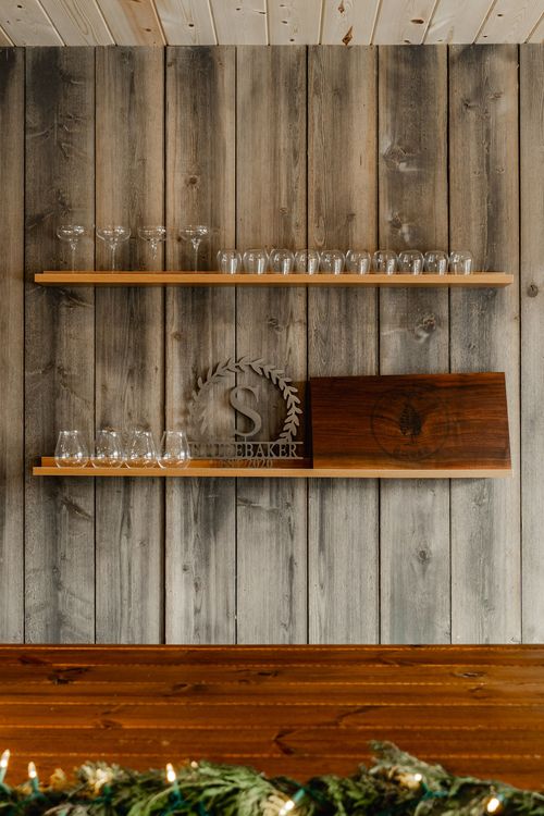 Close-up of open shelving with stemware and a laser-cut monogram plaque