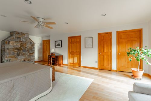 Bathroom with a curtained walk-in shower and floral window curtains