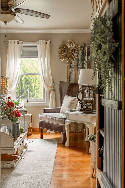 Living room corner with a mauve velvet chair, orb lamp, and ceiling fan