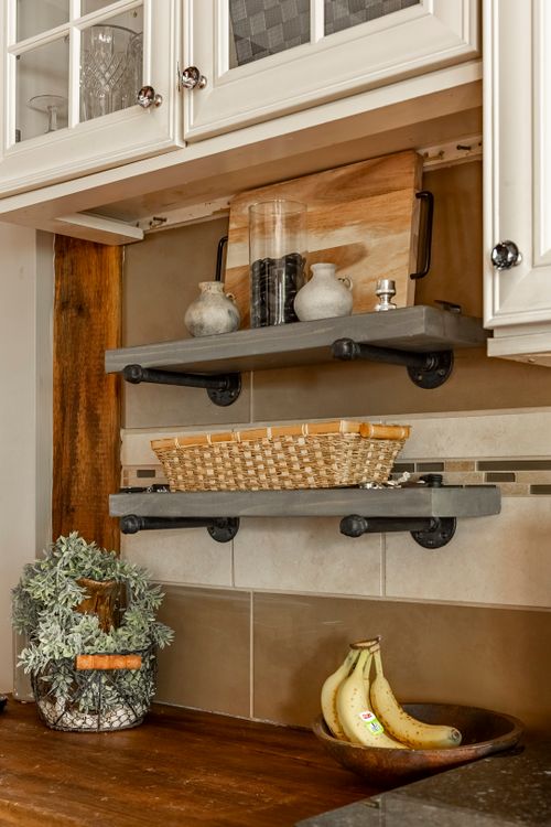 Kitchen backsplash detail with floating shelves, a woven basket, and fresh bananas in a bowl