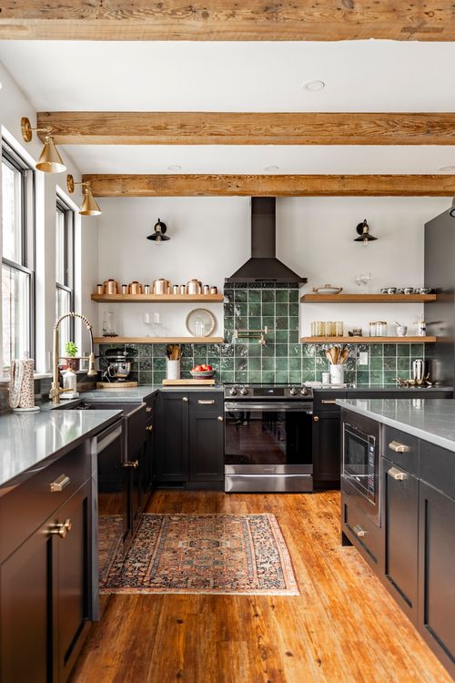 Kitchen with black range, copper accents, green tile backsplash and a vintage runner rug