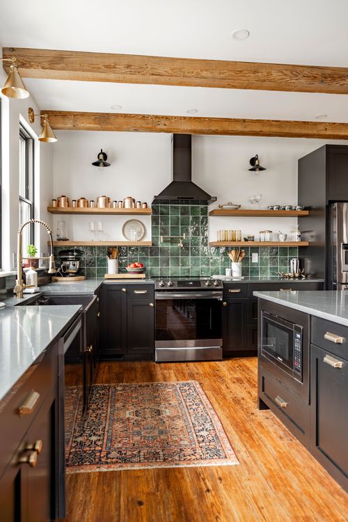 Kitchen with black range, gray quartz island, built-in microwave and a vintage runner rug