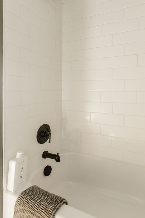 Bathroom shower with white subway tile and matte black fixtures