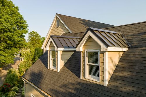 Close-up of standing-seam dormer roofs flanked by shingled gables